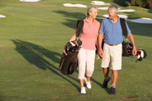 Man and wife golfing after men's pelvic floor therapy at UROSPOT.